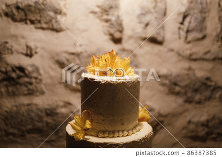 White wedding cake on a stone wall background 86387385