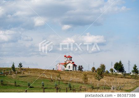 White brick church with red roof in the field White brick church with red roof in the field 86387386