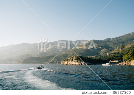 Boat sails to the beach of Villa Milocer. Montenegro Boat sails to the beach of Villa Milocer. Montenegro 86387500