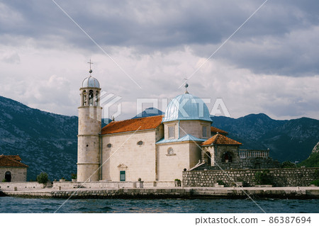 Church of Our Lady on the rocks on the island of Gospa od Skrpjela. Montenegro Church of Our Lady on the rocks on the island of Gospa od Skrpjela. Montenegro 86387694