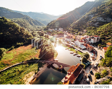 River Crnojevica near an old settlement among green mountains. Montenegro River Crnojevica near an old settlement among green mountains. Montenegro 86387708