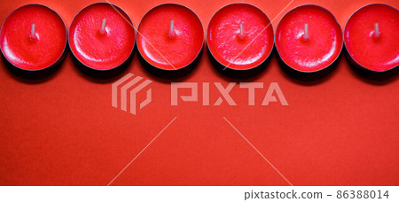 Red candles on a red background Red candles on a red background 86388014