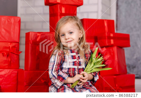 Adorable kid with a spring flower. Beautiful girl with flowers 86388217