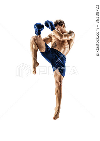 Full length of male kickboxer in blue sportswear on white background. muscular athlete fighting 86388723
