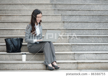 Elegant Businesswoman Working on Laptop 86388755