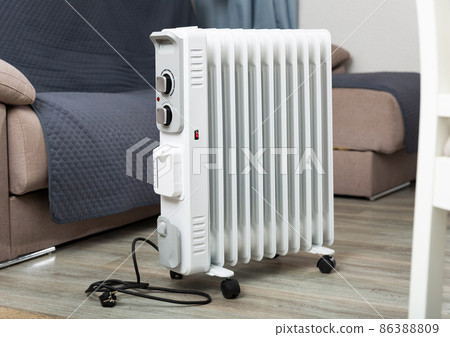 Electric oil-filled radiator for heating home in living room Electric oil-filled radiator for heating home in living room 86388809