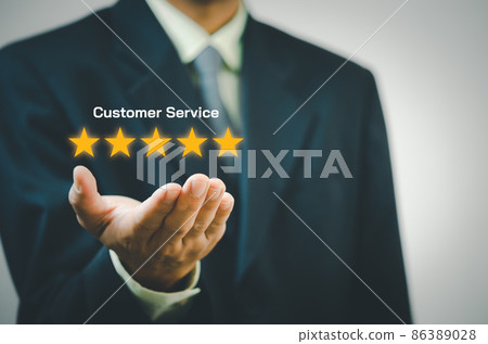 Businessman holding 5 stars on hands.Customer satisfaction and marketing survey rating concept 86389028