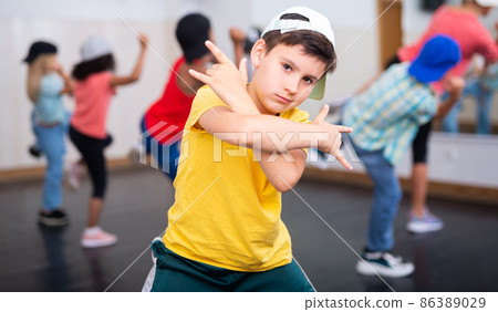 Tween boy hip hop dancer posing during group class 86389029