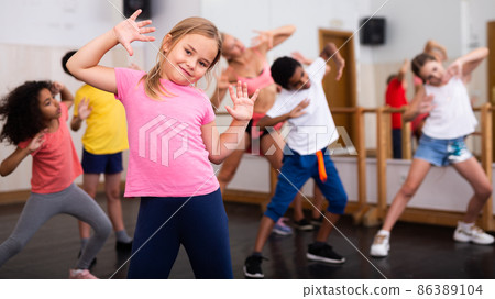 Girl exercising in group during dance class Girl exercising in group during dance class 86389104
