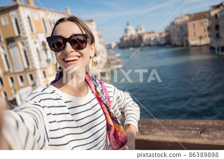 Woman traveling in Venice, Italy Woman traveling in Venice, Italy 86389898