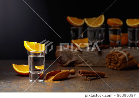 Tequila shots with orange and cinnamon. 86390387
