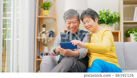 elderly couple use phone 86392126