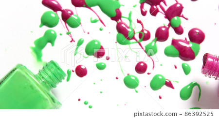 Pink and Green Spilled Nail Polish on White Background Pink and Green Spilled Nail Polish on White Background 86392525