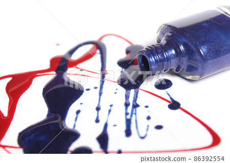 Red and Blue Spilled Nail Polish on White Background 86392554