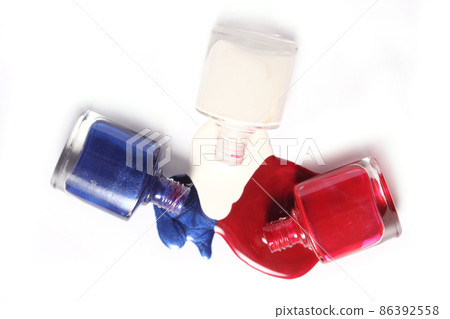 Red and Blue Spilled Nail Polish on White Background 86392558