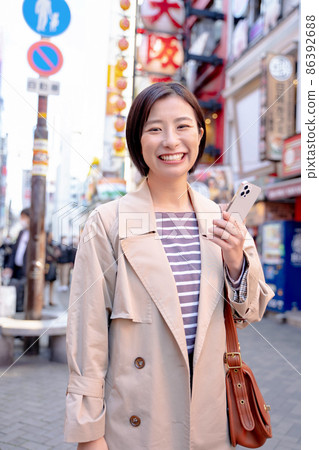 A woman enjoying sightseeing in Osaka A woman enjoying sightseeing in Osaka 86392688
