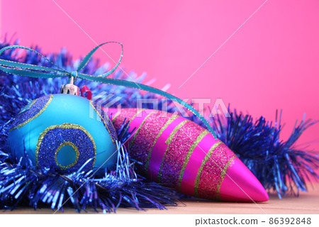 Christmas Ornaments and Tinsel on Pink Background, Shallow DOF 86392848