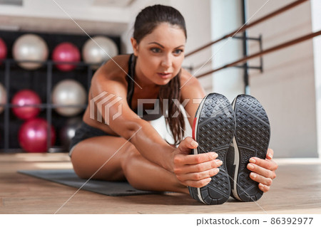 Gorgeous suntanned brunette doing exercises Gorgeous suntanned brunette doing exercises 86392977