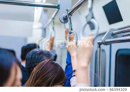 Passengers on a crowded train Passengers on a crowded train 86394309