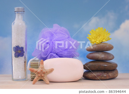 Soap and Massage Stones With Sea Shells on Blue Sky Background Soap and Massage Stones With Sea Shells on Blue Sky Background 86394644