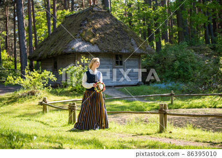 Latvian woman in traditional clothing. Ligo folk. Latvian woman in traditional clothing. Ligo folk. 86395010