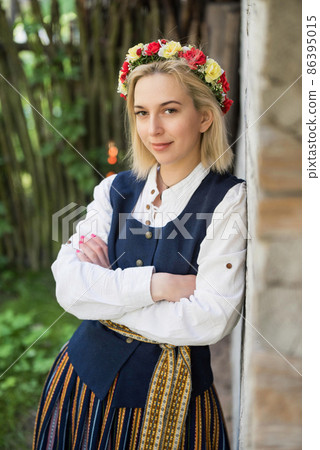 Latvian woman in traditional clothing. Ligo folk. 86395015