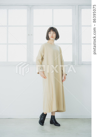 Woman in a beige dress 86395075