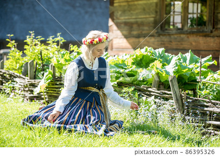 Latvian woman in traditional clothing. Ligo folk. Latvian woman in traditional clothing. Ligo folk. 86395326