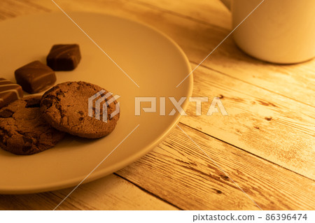 Chocolate chip cookies and chocolate on a plate 86396474