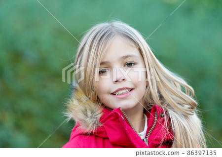 Girl with blond long hair smile on natural environment 86397135