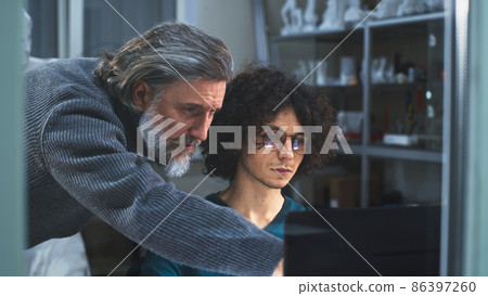 Male 3D designers using computer together 86397260