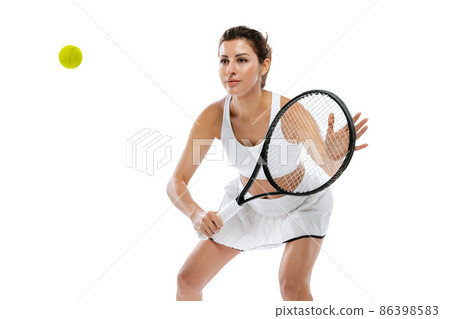 Studio shot of young sportive woman, tennis player training alone isolated on white background. Action, summer sports, fitness, sport concept. 86398583
