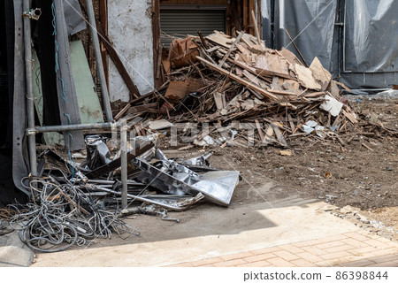 Sorted waste from demolition work: metal scraps and wood scraps 86398844