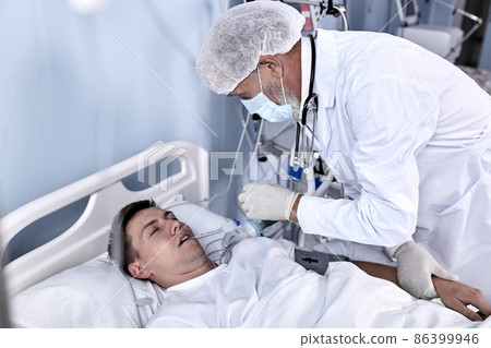 Experienced Male Doctor Check the Pulse and the Patient's Health Condition Lying On Bed Experienced Male Doctor Check the Pulse and the Patient's Health Condition Lying On Bed 86399946