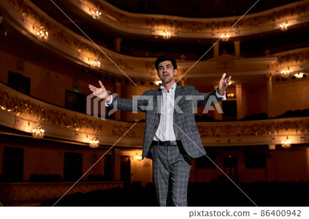 young caucasian man performing opera or singing at a concert or show, talented young caucasian man performing opera or singing at a concert or show, talented 86400942
