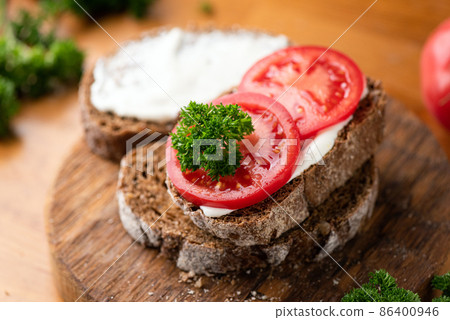 Rye bread toast with soft white cheese ricotta and fresh tomato Rye bread toast with soft white cheese ricotta and fresh tomato 86400946
