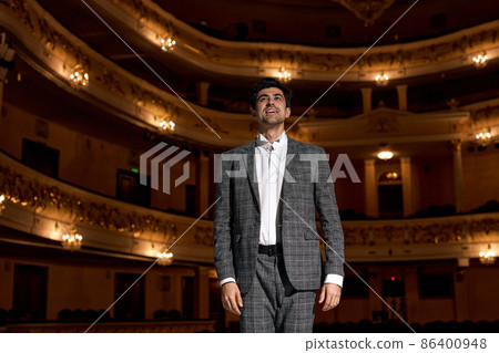 Showman. Young male entertainer, presenter or actor on stage. male public speaker Showman. Young male entertainer, presenter or actor on stage. male public speaker 86400948
