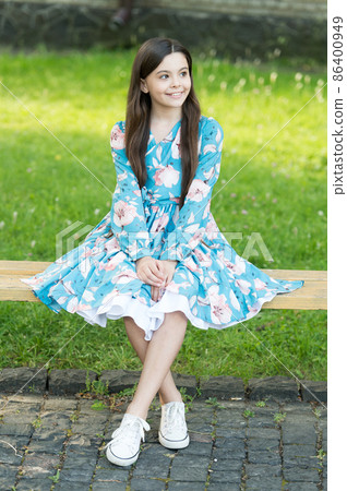 Little girl with long hair relaxing in park sunny day green grass Little girl with long hair relaxing in park sunny day green grass 86400949
