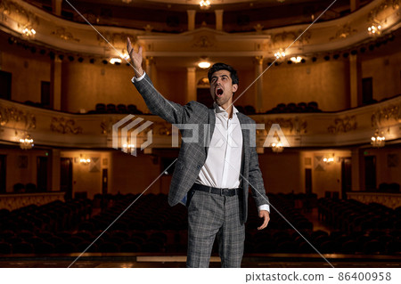 young caucasian man performing opera or singing at a concert or show, talented young caucasian man performing opera or singing at a concert or show, talented 86400958