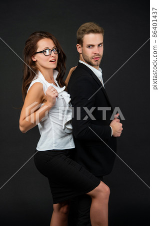 stylish formal couple in love in business look on black background, partners 86401437