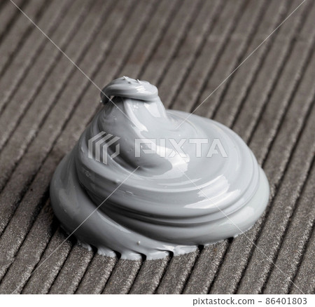 High quality automotive high temperature sealant. Gray universal one-component sealant, macro High quality automotive high temperature sealant. Gray universal one-component sealant, macro 86401803