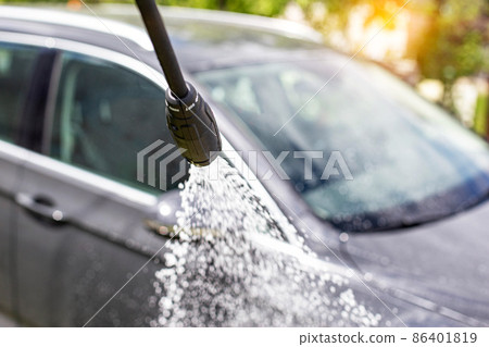 Car wash with modern car shampoo using a high pressure washer in summer. Background, cleaning cars from dirt Car wash with modern car shampoo using a high pressure washer in summer. Background, cleaning cars from dirt 86401819