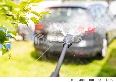 Car wash with modern car shampoo using a high pressure washer in summer. Background, cleaning cars from dirt 86401820