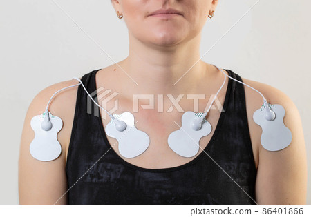 Treatment and relaxation of muscles on the human body with the help of an electronic apunctuator medical device. Skin massage, home physiotherapy. Stimulation 86401866