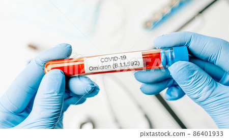 Omicron mutation coronavirus variant. Medical laboratory doctor holding test tube in hospital laboratory. Pandemic prevention. Clinical research. Omicron mutation coronavirus variant. Medical laboratory doctor holding test tube in hospital laboratory. Pandemic prevention. Clinical research. 86401933