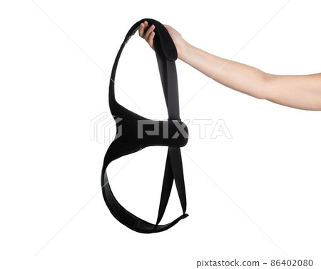 Medical posture corrector in hand on a white background. Back pain treatment concept, isolate. Rehabilitation spine Medical posture corrector in hand on a white background. Back pain treatment concept, isolate. Rehabilitation spine 86402080