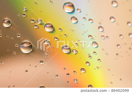 Water drops on glass surface in the sun Water drops on glass surface in the sun 86402099