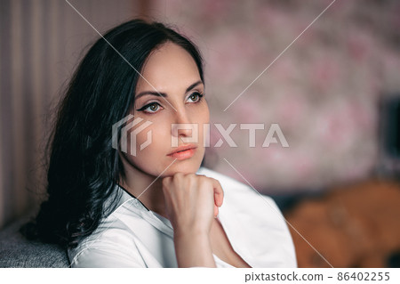 beautiful brunette girl in white shirt at home beautiful brunette girl in white shirt at home 86402255