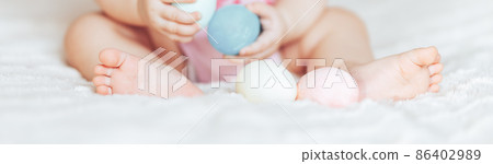 Cute little baby girl, playing with colorful easter eggs 86402989