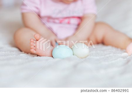 Cute little baby girl, playing with colorful easter eggs Cute little baby girl, playing with colorful easter eggs 86402991